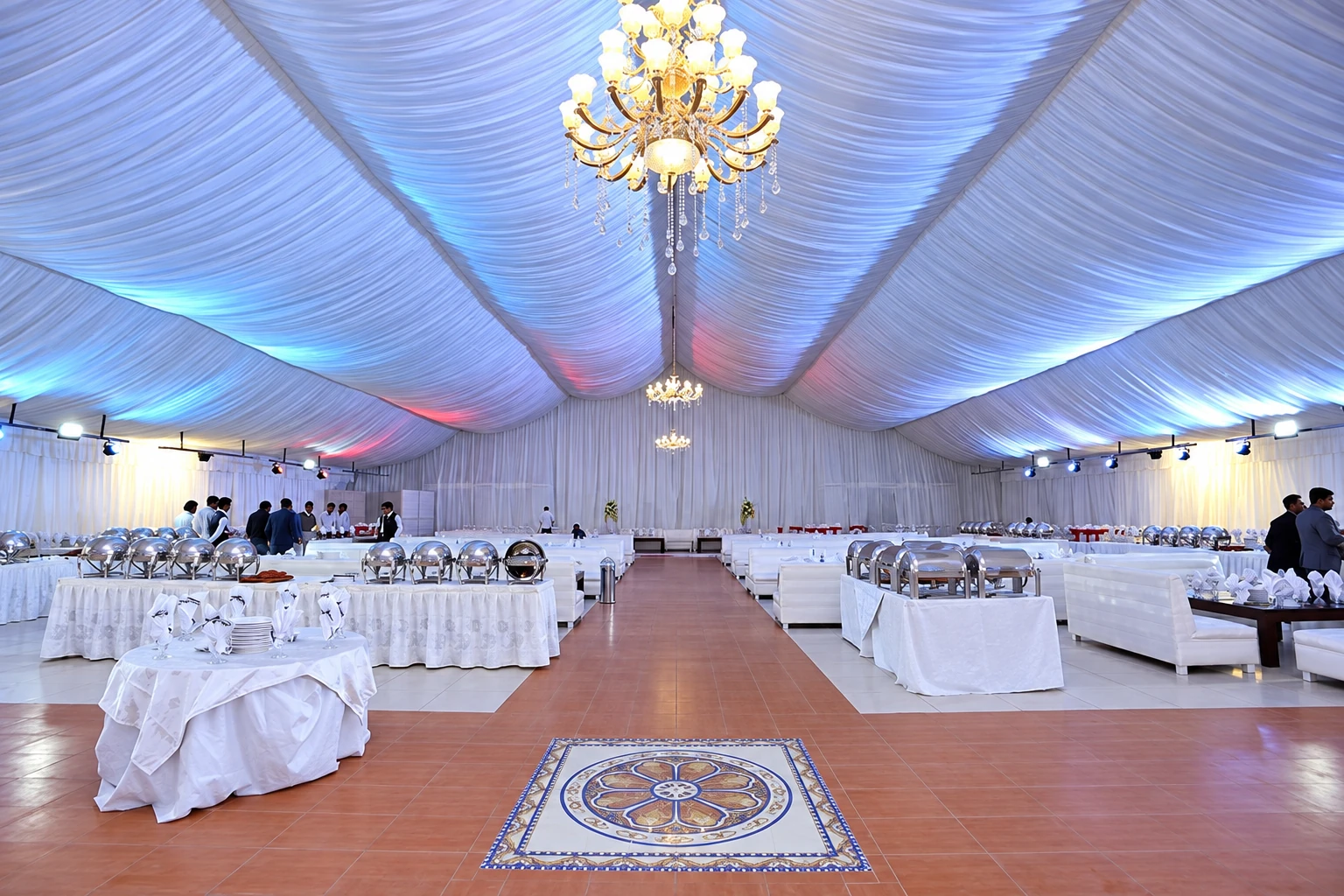 Buffet setup with chafing dishes under a draped marquee ceiling