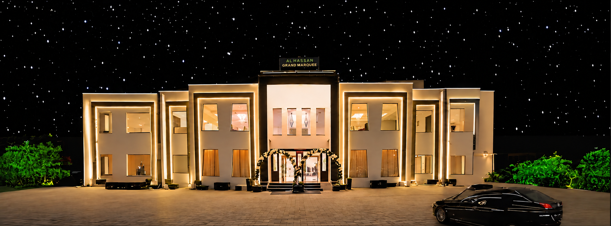 Al Hassan Grand Marquee facade at night under a starry sky