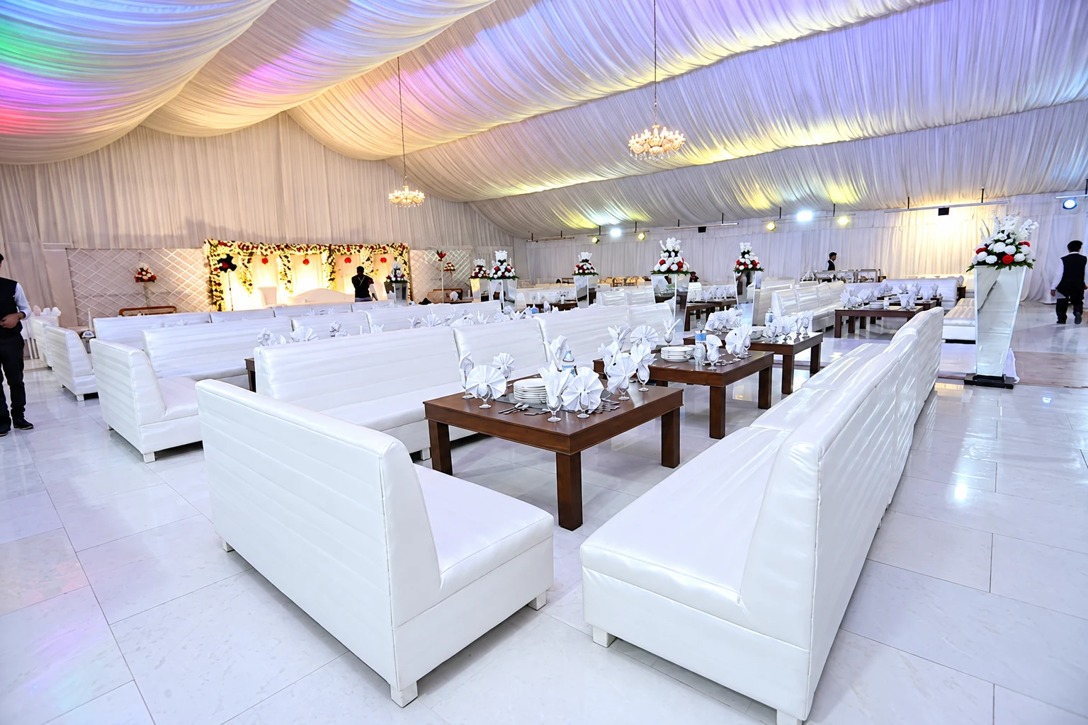 Marquee hall with white leather sofas and dining tables