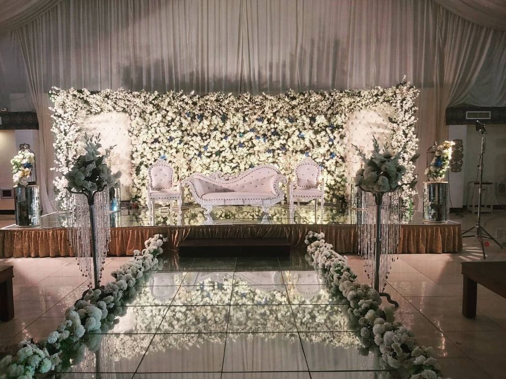 White floral wall wedding stage with mirror walkway